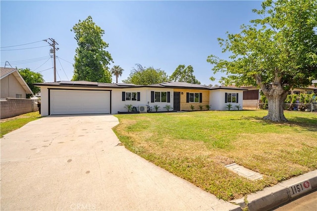 1151 Grand Ave, Colton, CA 92324 - single story home with a garage, driveway, roof mounted solar panels, and stucco siding
