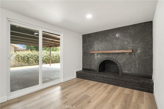 1151 Grand Ave, Colton, CA 92324 - unfurnished living room with a brick fireplace, wood finished floors, and recessed lighting