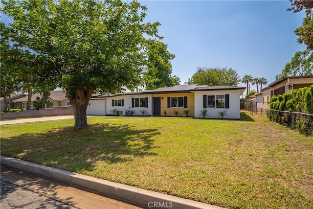 1151 Grand Ave, Colton, CA 92324 - ranch-style house with a garage, solar panels, and driveway