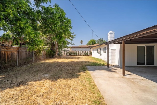 1151 Grand Ave, Colton, CA 92324 - fenced backyard with a patio area and an attached carport