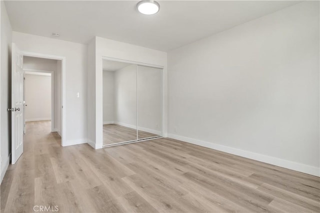 1151 Grand Ave, Colton, CA 92324 - unfurnished bedroom featuring light wood finished floors and a closet