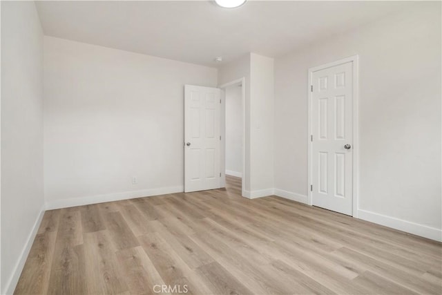 1151 Grand Ave, Colton, CA 92324 - unfurnished bedroom featuring light wood-style flooring and baseboards