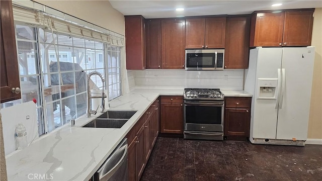 42269 Whittier Ave, Hemet, CA 92544 - kitchen featuring appliances with stainless steel finishes, backsplash, light stone countertops, and recessed lighting