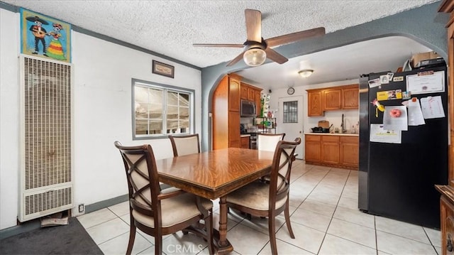 3510 E 2nd St, Los Angeles, CA 90063 - dining space with a heating unit, arched walkways, ceiling fan, light tile patterned floors, and a textured ceiling