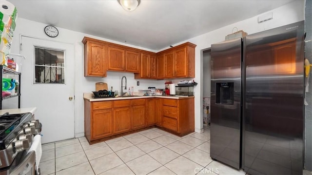 3510 E 2nd St, Los Angeles, CA 90063 - kitchen featuring appliances with stainless steel finishes, a sink, light countertops, and brown cabinets