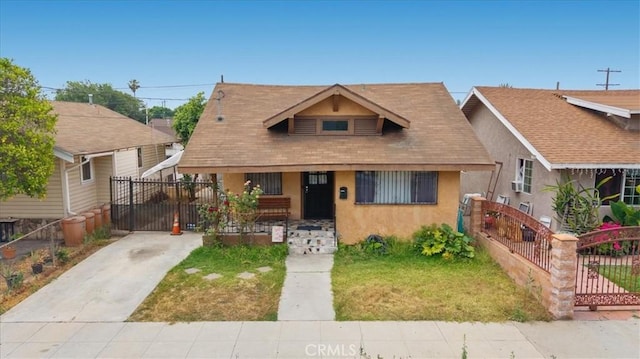 3510 E 2nd St, Los Angeles, CA 90063 - bungalow with stucco siding, a porch, concrete driveway, and a gate
