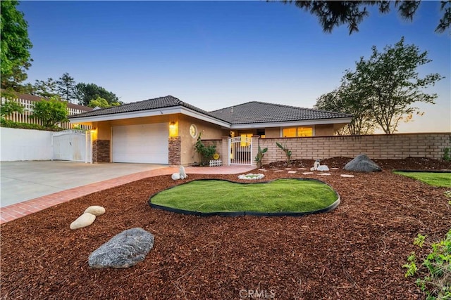 1601 Calle De Armonia, San Dimas, CA 91773 - view of front of house with a gate, stucco siding, a tile roof, an attached garage, and concrete driveway