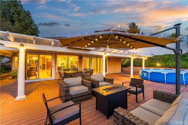 1601 Calle De Armonia, San Dimas, CA 91773 - deck at dusk with an outdoor pool, an outdoor living space with a fire pit, and outdoor dining space