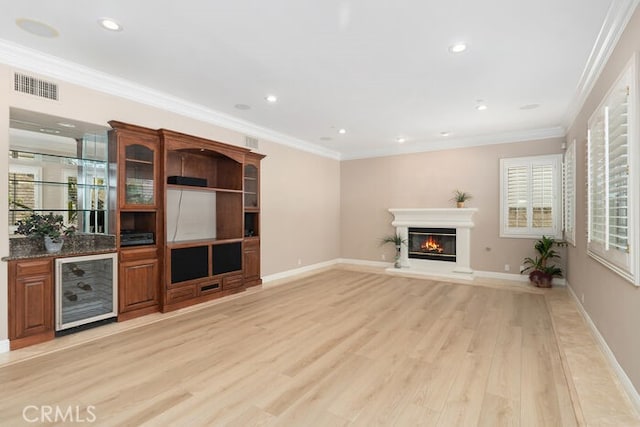 3264 Silver Maple Dr, Yorba Linda, CA 92886 - unfurnished living room with beverage cooler, light wood-type flooring, a glass covered fireplace, recessed lighting, and crown molding