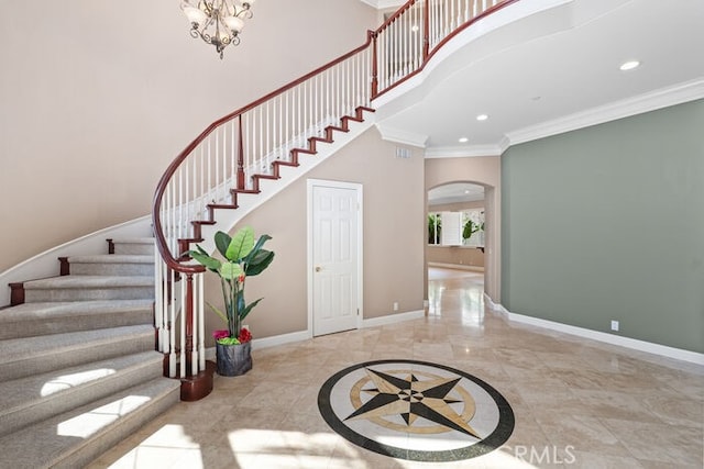 3264 Silver Maple Dr, Yorba Linda, CA 92886 - foyer entrance featuring ornamental molding, a towering ceiling, arched walkways, recessed lighting, and baseboards