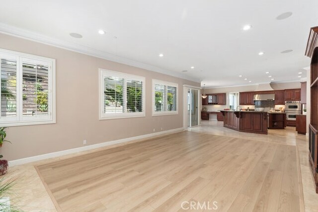 3264 Silver Maple Dr, Yorba Linda, CA 92886 - unfurnished living room featuring crown molding, light wood finished floors, recessed lighting, and baseboards