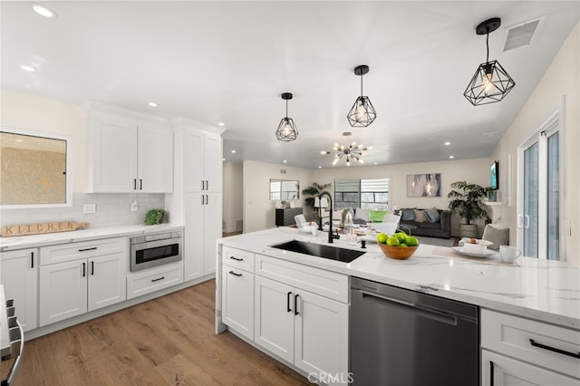6880 Topaz St, Rancho Cucamonga, CA 91701 - kitchen featuring dishwashing machine, open floor plan, recessed lighting, light wood finished floors, and white cabinetry