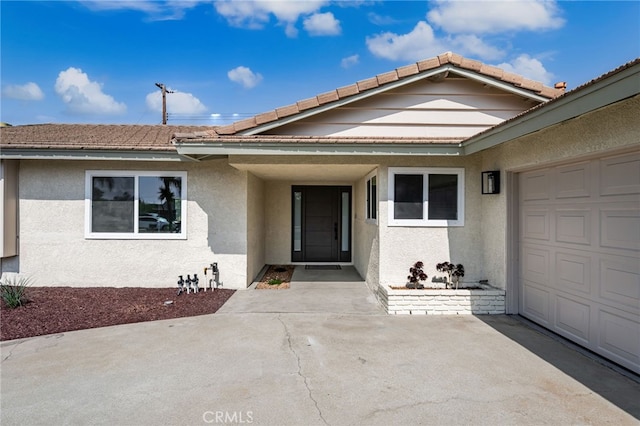 6880 Topaz St, Rancho Cucamonga, CA 91701 - doorway to property with stucco siding, an attached garage, and a tiled roof