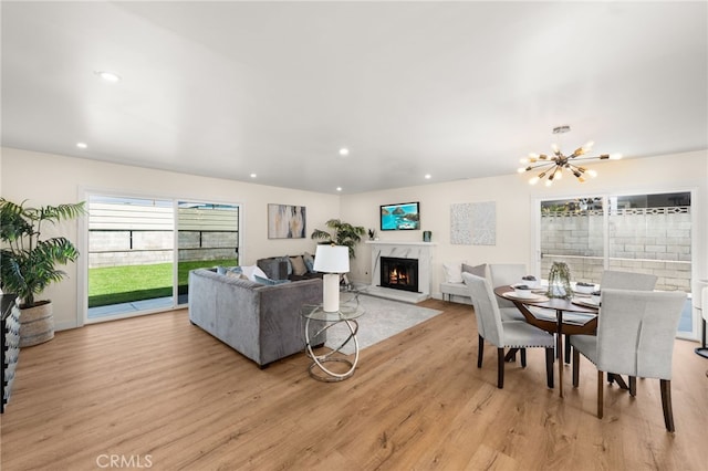 6880 Topaz St, Rancho Cucamonga, CA 91701 - living area with light wood-style floors, a high end fireplace, a chandelier, and recessed lighting