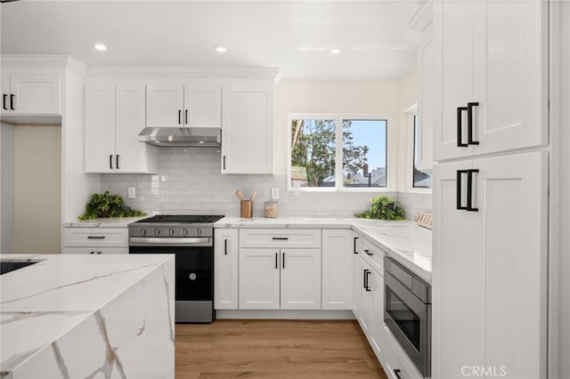 6880 Topaz St, Rancho Cucamonga, CA 91701 - kitchen with stainless steel appliances, under cabinet range hood, white cabinets, decorative backsplash, and recessed lighting