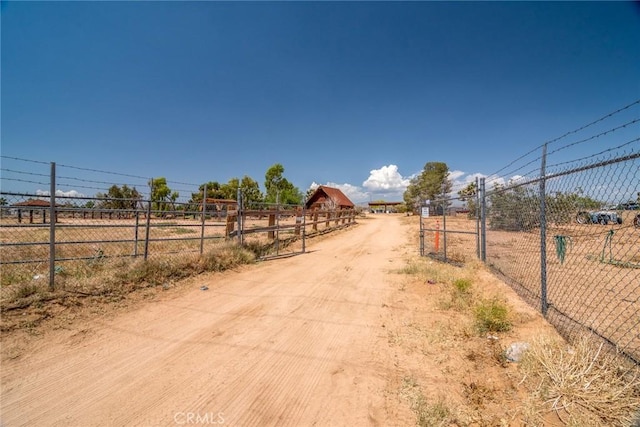 1676 Avalon Ave, Yucca Valley, CA 92284 - view of dirt / gravel road with a gated entry and a rural view