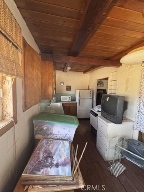 1676 Avalon Ave, Yucca Valley, CA 92284 - kitchen with white appliances, wood ceiling with exposed beams, dark wood finished floors, brown cabinetry, and light countertops