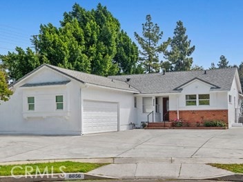 8856 Fullbright Ave, Winnetka, CA 91306 - view of front of house featuring concrete driveway, a garage, and brick siding