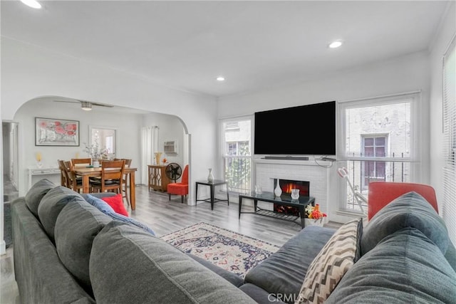 1732 W 48th St, Los Angeles, CA 90062 - living area featuring arched walkways, recessed lighting, wood finished floors, a fireplace, and a wall mounted air conditioner