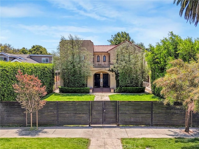 1732 W 48th St, Los Angeles, CA 90062 - mediterranean / spanish home featuring a fenced front yard, french doors, stucco siding, a gate, and a tiled roof