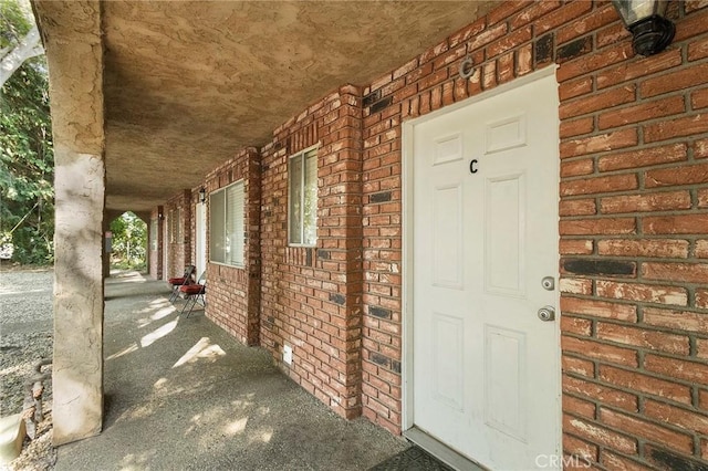 403 Maple St, Chico, CA 95928 - view of exterior entry featuring covered porch and brick siding