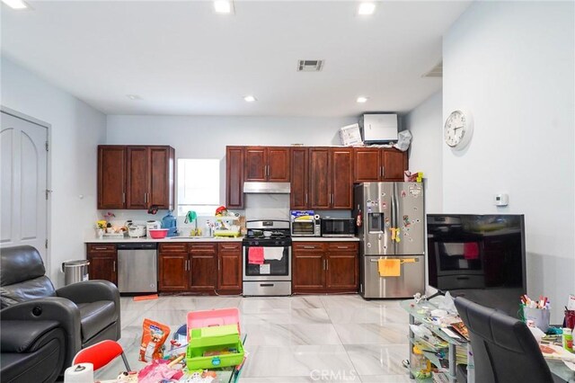 13672 Monroe St, Westminster, CA 92683 - kitchen with appliances with stainless steel finishes, under cabinet range hood, open floor plan, light countertops, and recessed lighting