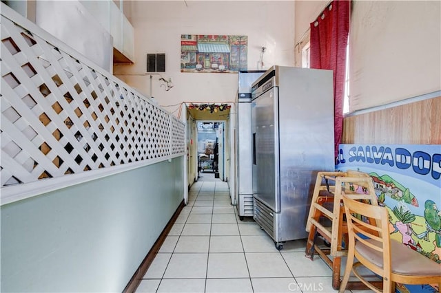 1262 Fedora St, Los Angeles, CA 90006 - kitchen with stainless steel fridge and light tile patterned floors