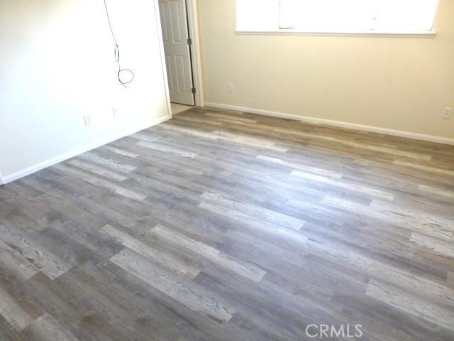 6070 Baileya Ave Unit 29, Palms, CA 92277 - unfurnished room featuring wood finished floors and baseboards