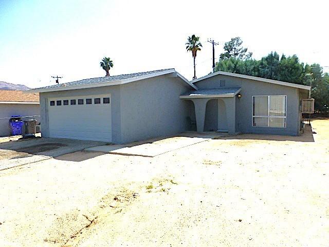 6070 Baileya Ave Unit 29, Palms, CA 92277 - single story home with stucco siding and a garage