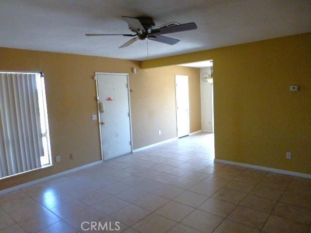 6070 Baileya Ave Unit 29, Palms, CA 92277 - tiled empty room with a ceiling fan and baseboards