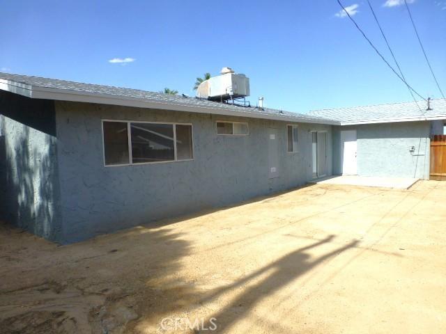 6070 Baileya Ave Unit 29, Palms, CA 92277 - back of house featuring a patio, stucco siding, and central AC unit
