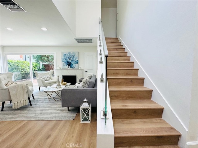 32942 Paseo Del Lucero, San Juan Capistrano, CA 92675 - staircase featuring wood finished floors, a premium fireplace, and recessed lighting