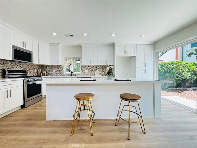 32942 Paseo Del Lucero, San Juan Capistrano, CA 92675 - kitchen with appliances with stainless steel finishes, healthy amount of natural light, a breakfast bar area, and recessed lighting
