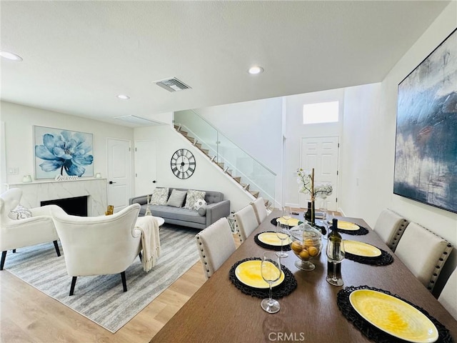 32942 Paseo Del Lucero, San Juan Capistrano, CA 92675 - dining area with stairway, wood finished floors, recessed lighting, and a premium fireplace
