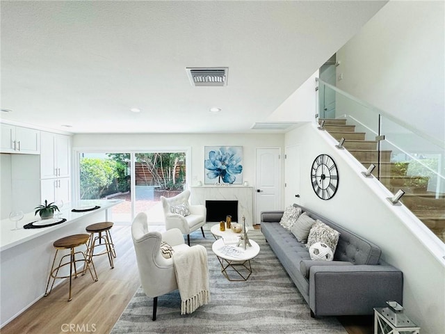 32942 Paseo Del Lucero, San Juan Capistrano, CA 92675 - living area with light wood-style flooring, stairway, recessed lighting, and a fireplace