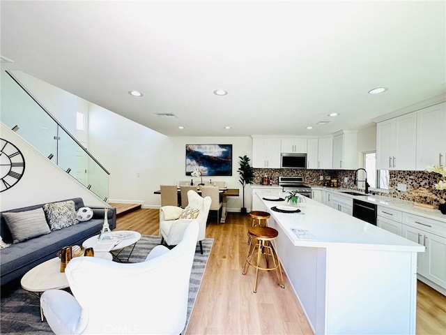 32942 Paseo Del Lucero, San Juan Capistrano, CA 92675 - living area featuring light wood finished floors, stairs, and recessed lighting