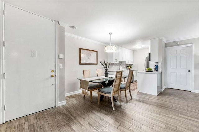 564 N Bellflower Blvd Unit 120, Long Beach, CA 90814 - dining room with ornamental molding, light wood-type flooring, and baseboards