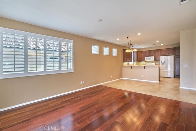 1558 Rockrose Way, Beaumont, CA 92223 - unfurnished living room featuring light wood-style floors, a chandelier, recessed lighting, and baseboards