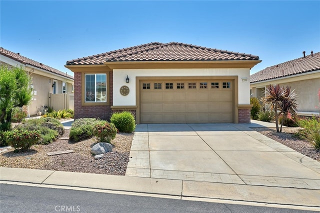 1558 Rockrose Way, Beaumont, CA 92223 - mediterranean / spanish house with a tiled roof, brick siding, driveway, a garage, and stucco siding