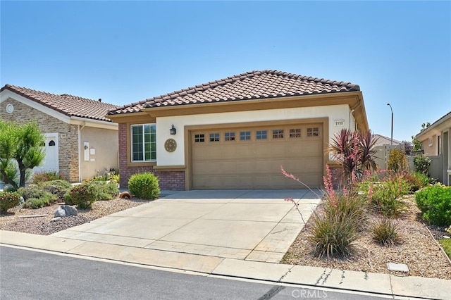 1558 Rockrose Way, Beaumont, CA 92223 - mediterranean / spanish-style house with driveway, an attached garage, a tiled roof, and stucco siding