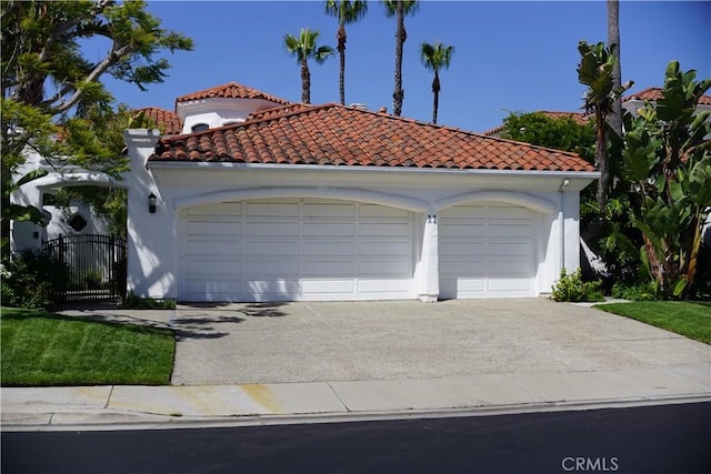 11 Terraza Del Mar, Dana Point, CA 92629 - mediterranean / spanish house featuring a garage, a tiled roof, stucco siding, and a gate