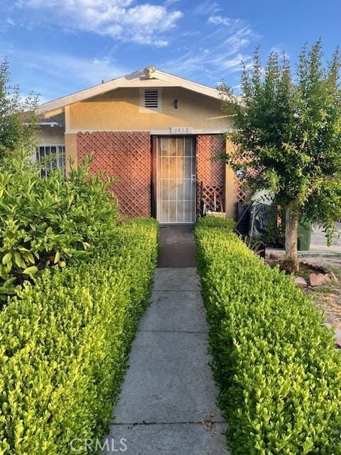 1418 W 70th St, Los Angeles, CA 90047 - property entrance with stucco siding and brick siding