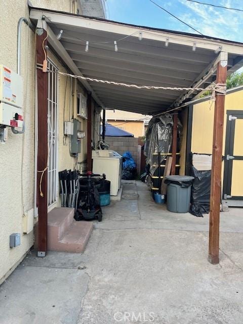 1418 W 70th St, Los Angeles, CA 90047 - view of parking featuring washing machine and clothes dryer and an attached carport
