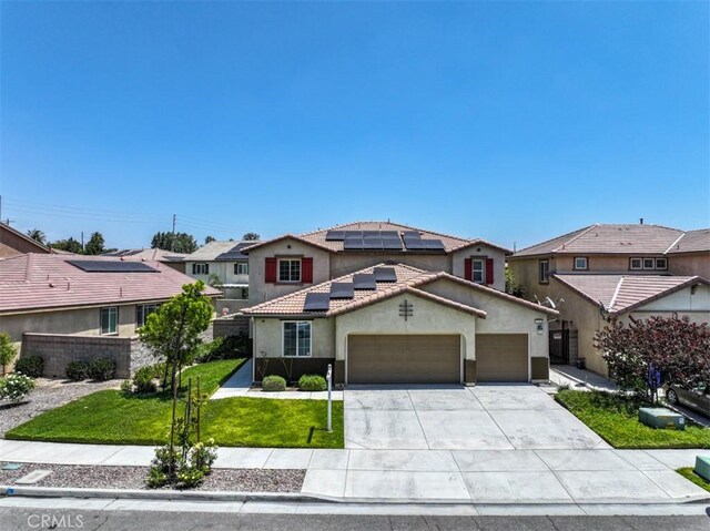 6886 Cache Way, Jurupa Valley, CA 91752 - view of front of house featuring a garage, a front lawn, stucco siding, roof mounted solar panels, and driveway