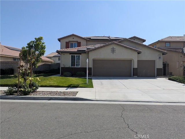 6886 Cache Way, Jurupa Valley, CA 91752 - mediterranean / spanish-style home featuring a garage, driveway, roof mounted solar panels, stucco siding, and a tile roof