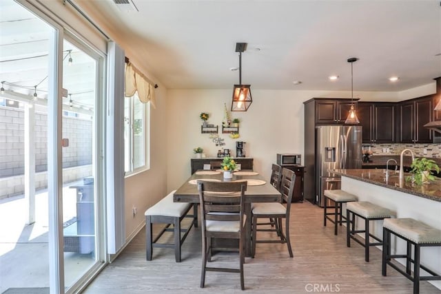 6886 Cache Way, Jurupa Valley, CA 91752 - dining area with light wood-style floors and recessed lighting