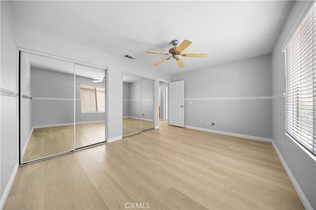12337 Columbia Ln, Eastvale, CA 91752 - unfurnished bedroom featuring two closets, wood finished floors, and ceiling fan