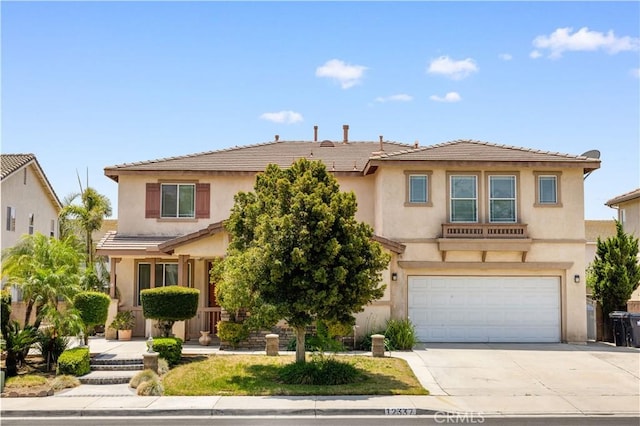 12337 Columbia Ln, Eastvale, CA 91752 - view of front of home featuring an attached garage, concrete driveway, stucco siding, and a tile roof