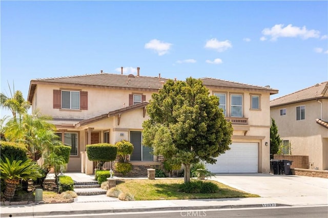 12337 Columbia Ln, Eastvale, CA 91752 - view of front of home with a garage, driveway, and stucco siding
