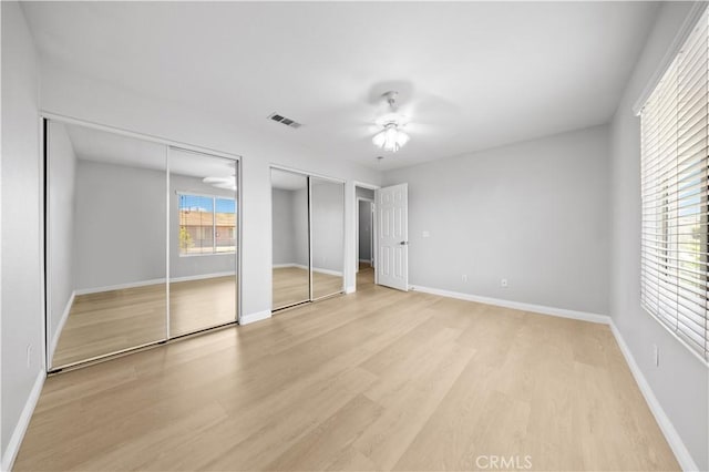 12337 Columbia Ln, Eastvale, CA 91752 - unfurnished bedroom with two closets, light wood-type flooring, and a ceiling fan
